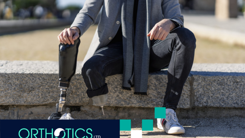 A disabled young man with foot prosthesis sitting outdoor