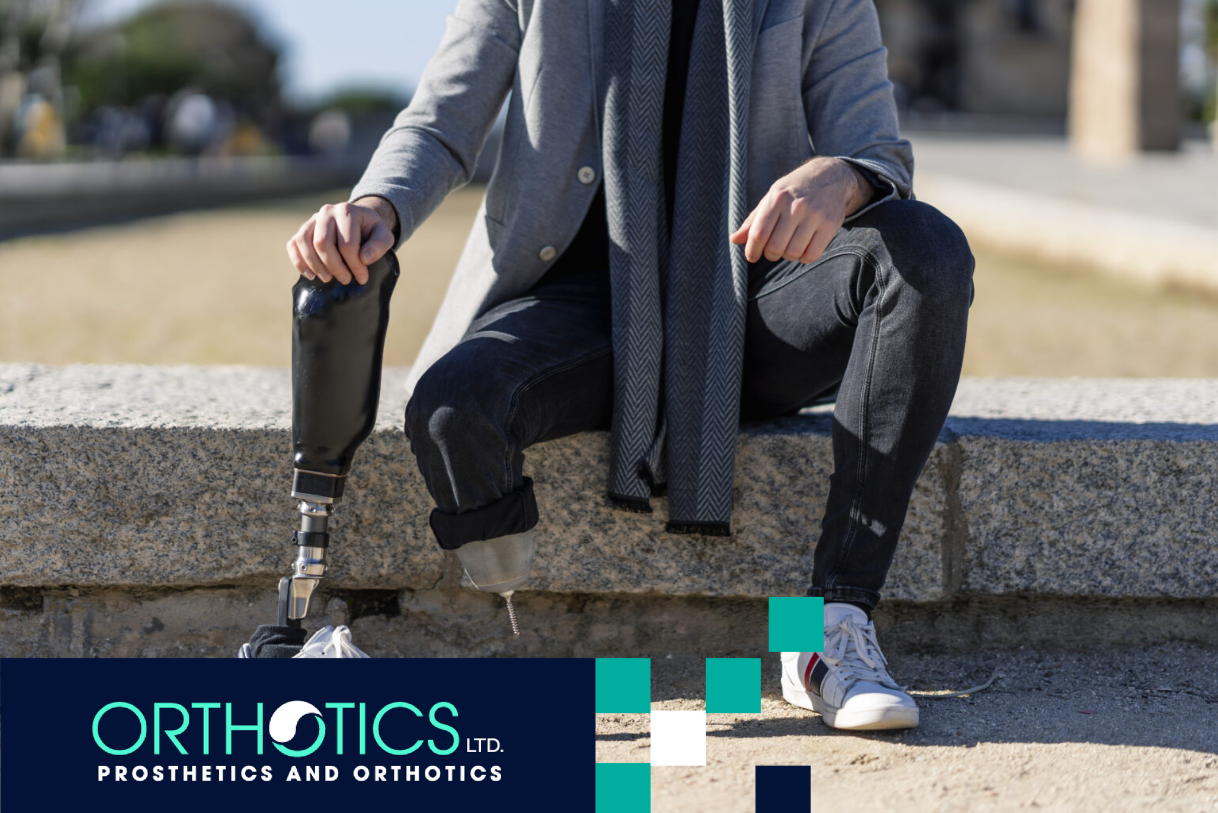 A disabled young man with foot prosthesis sitting outdoor