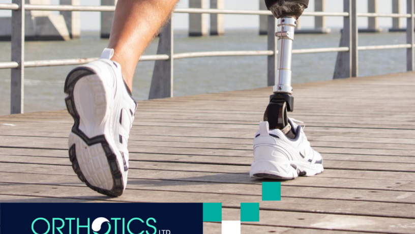 An amputee with prosthetics is running outdoors