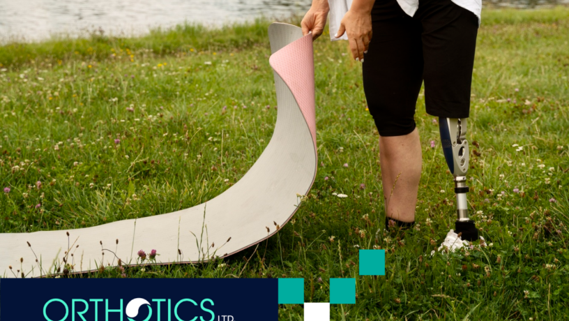 A teen with prosthetics doing yoga outdoors