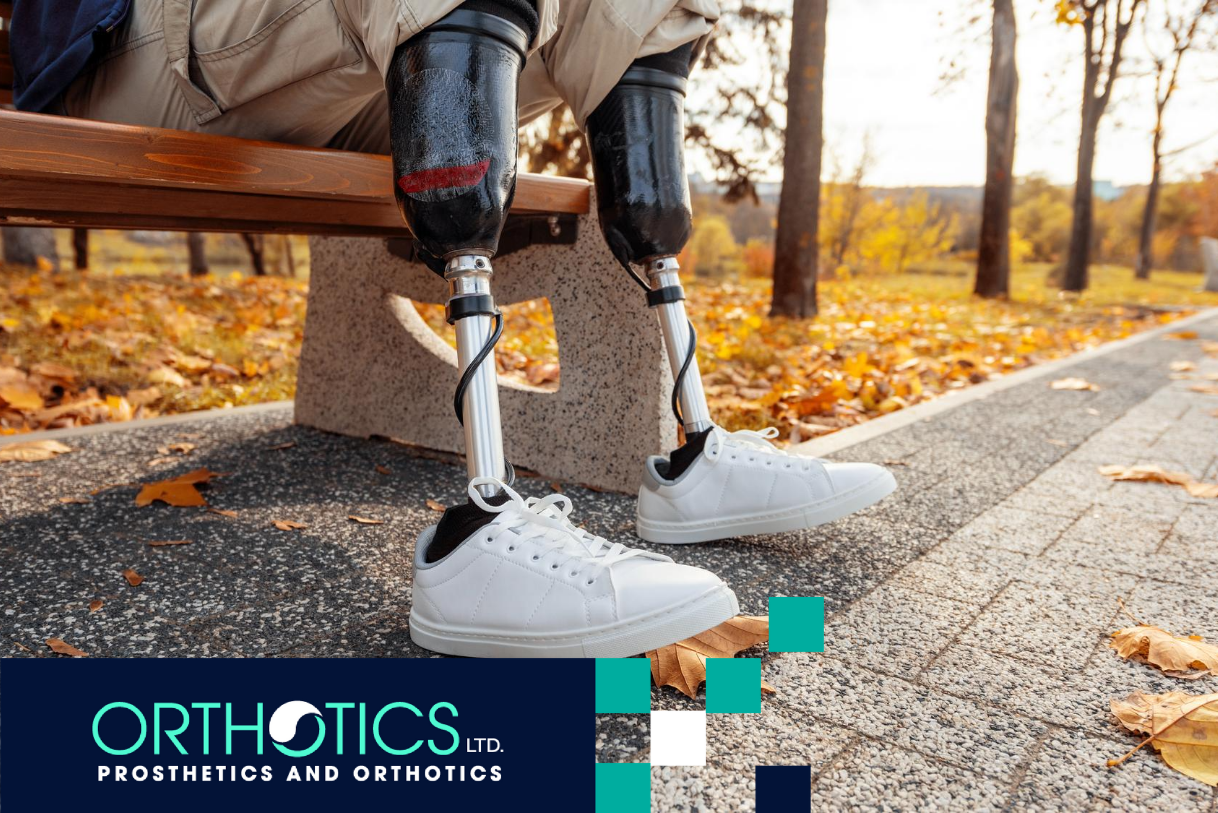 A bilateral amputee wearing prosthetics sitting on a bench in a park
