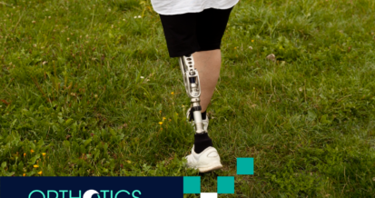 An amputee wearing prosthetics is walking on grass