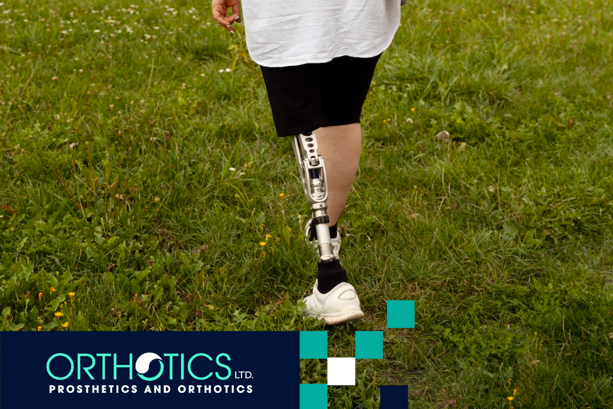 An amputee wearing prosthetics is walking on grass