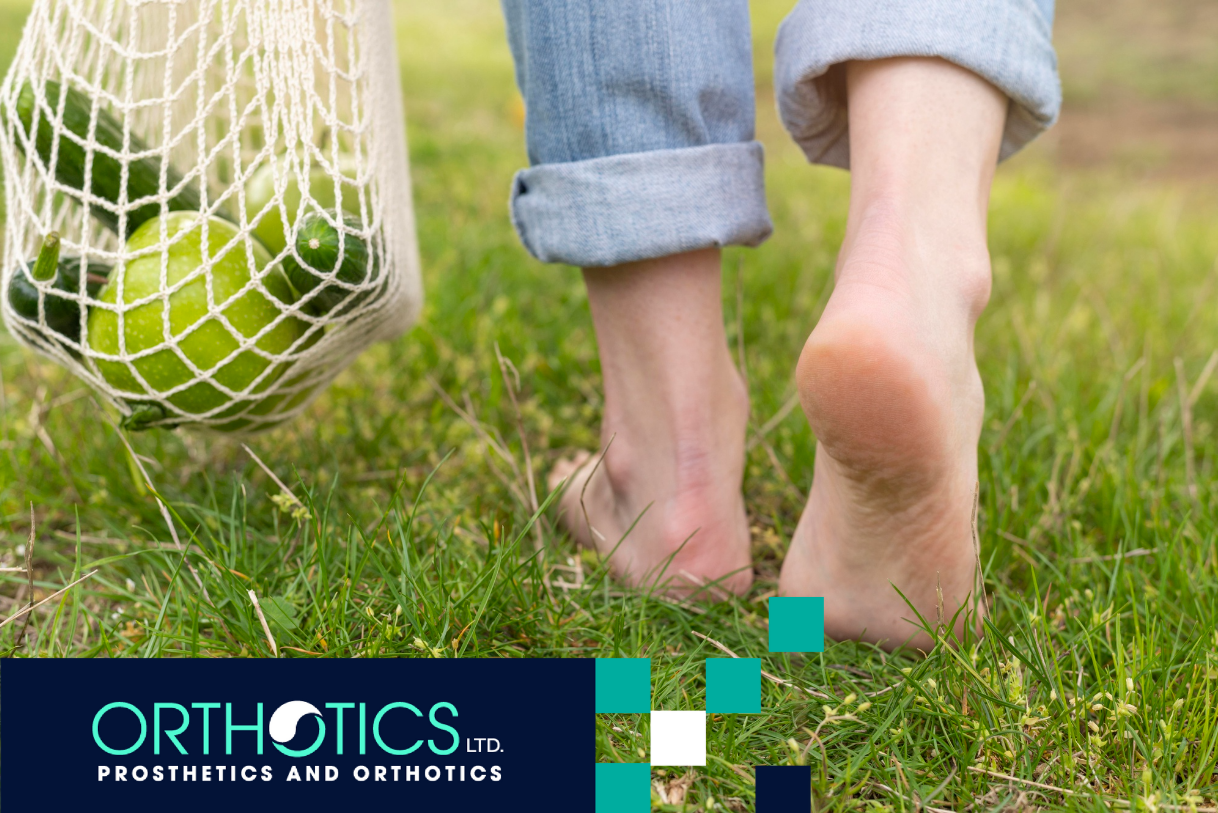 A person walking on the grass barefoot