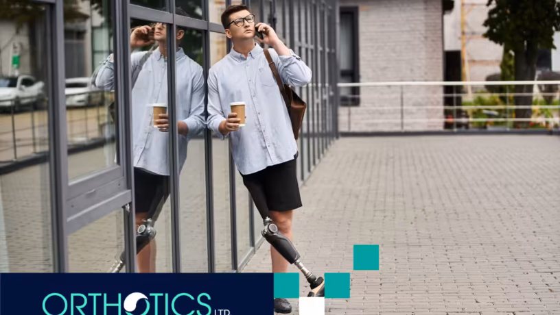 An amputee with a prosthetic limb is on the phone while holding a cup of coffee