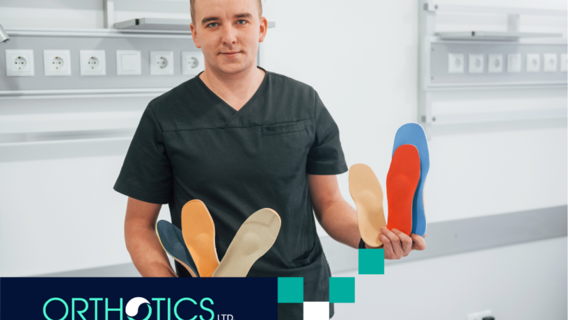 A guy holding shoe insoles