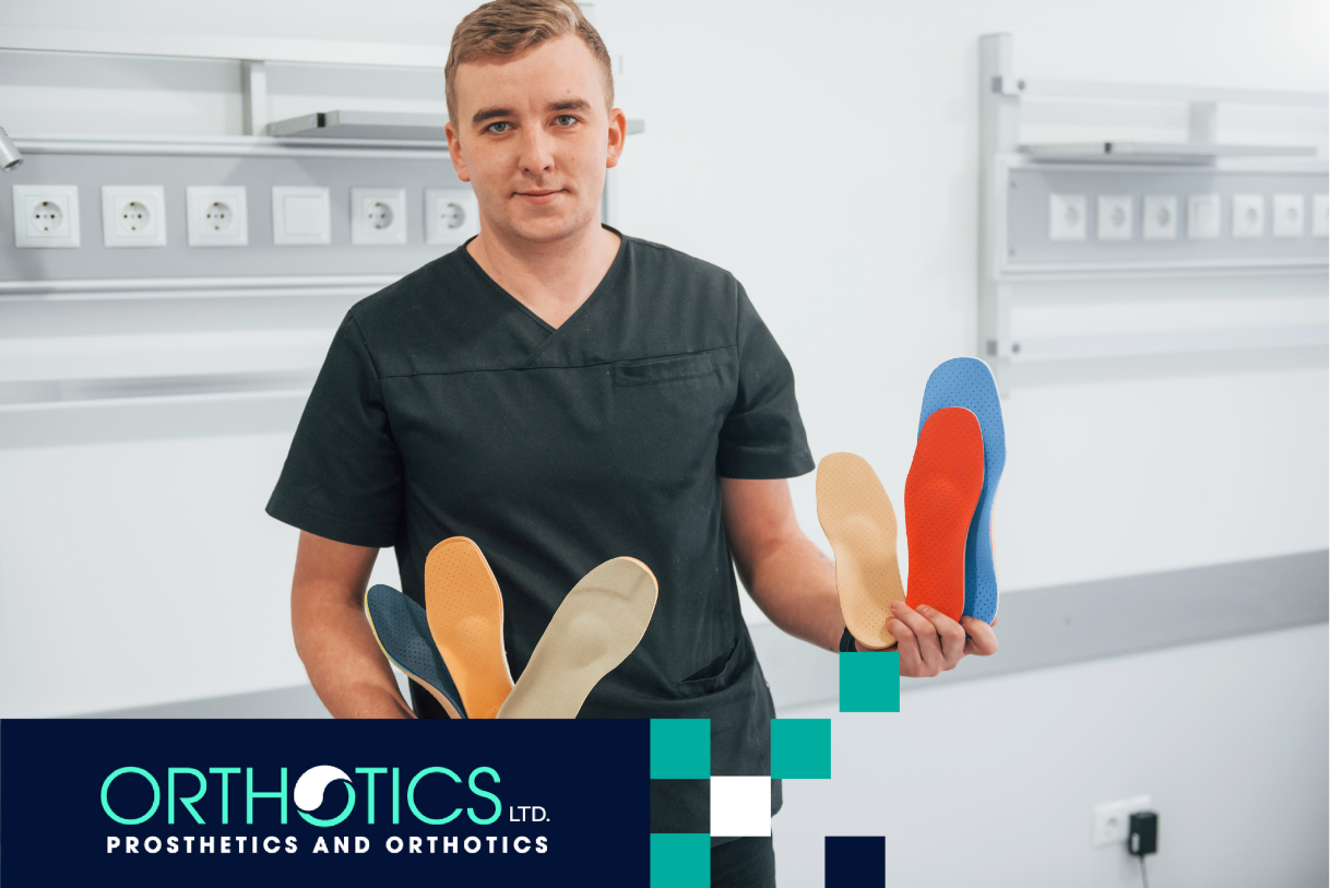 A guy holding shoe insoles