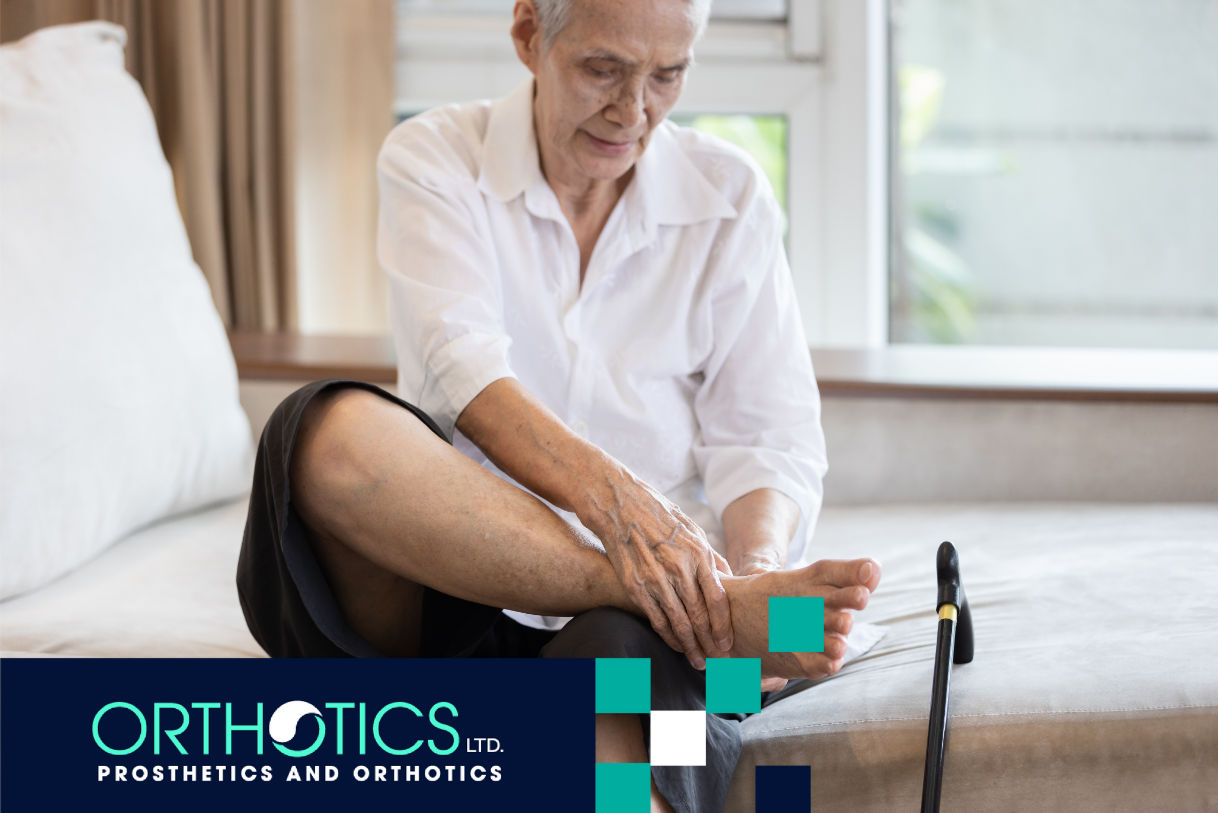 An elderly person sitting on a bed holding her foot