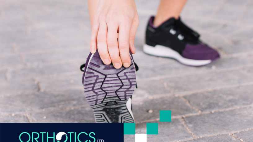 A woman is stretching her foot