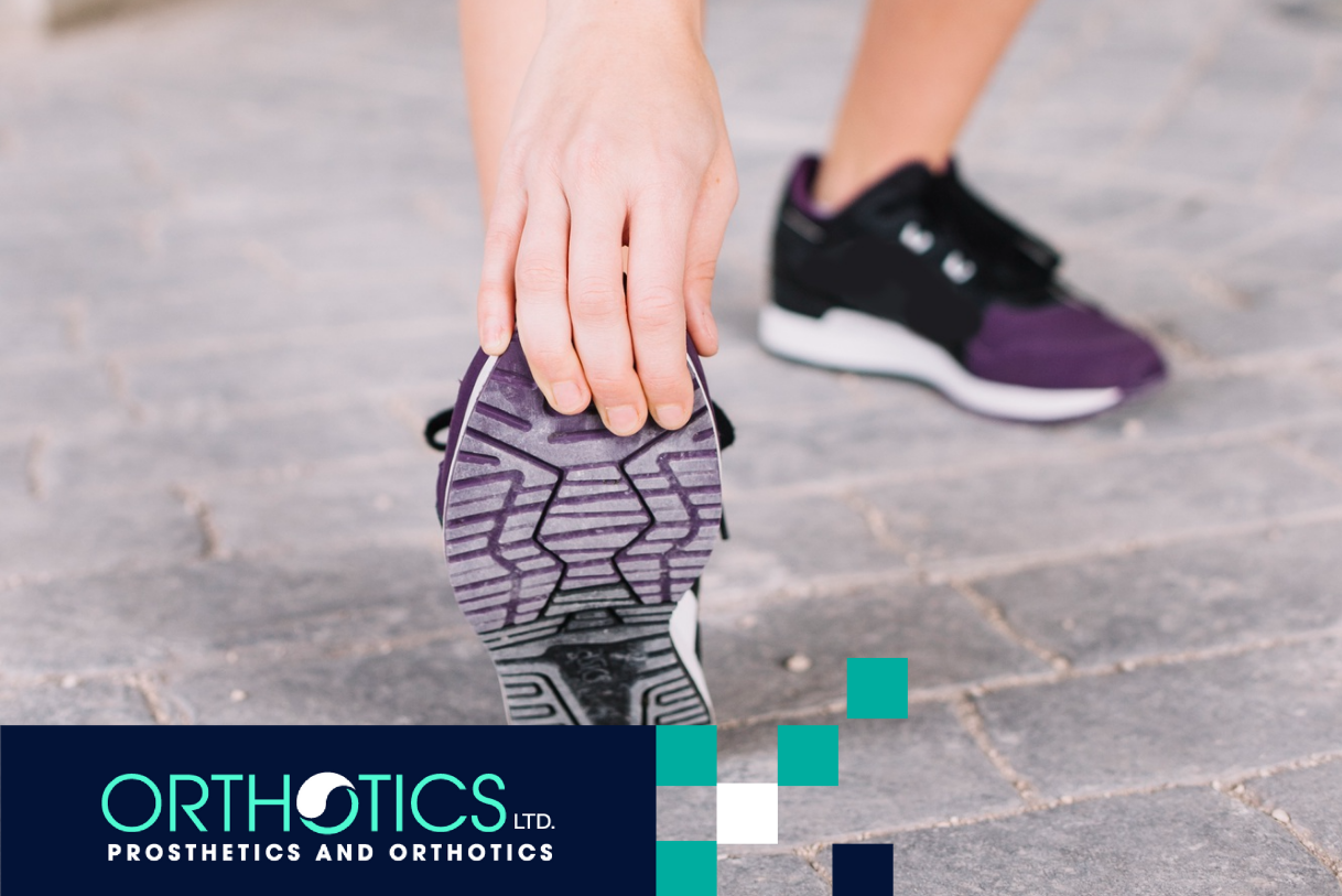 A woman is stretching her foot