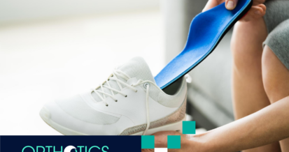 A man putting an insole into a shoe