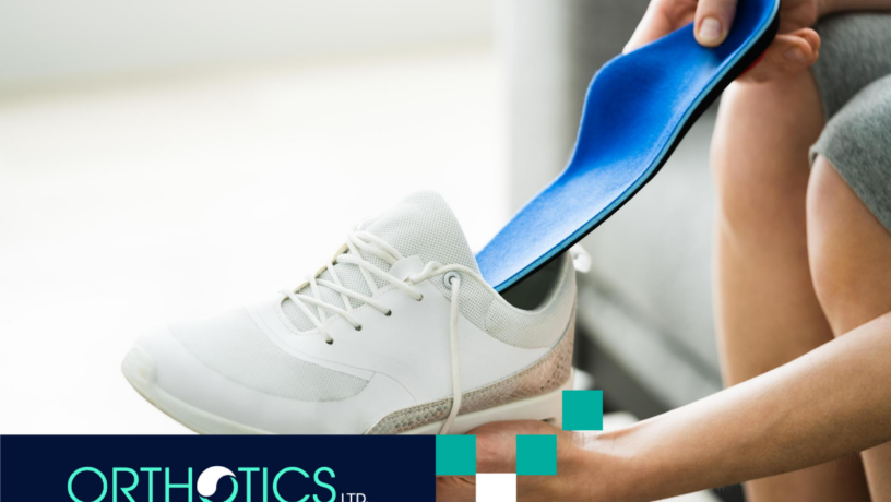 A man putting an insole into a shoe