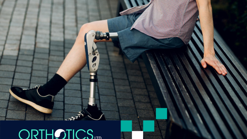 An amputee wearing prosthetics sitting on a bench