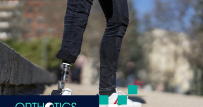An amputee wearing a prosthetic standing outdoors wearing jeans and white shoes