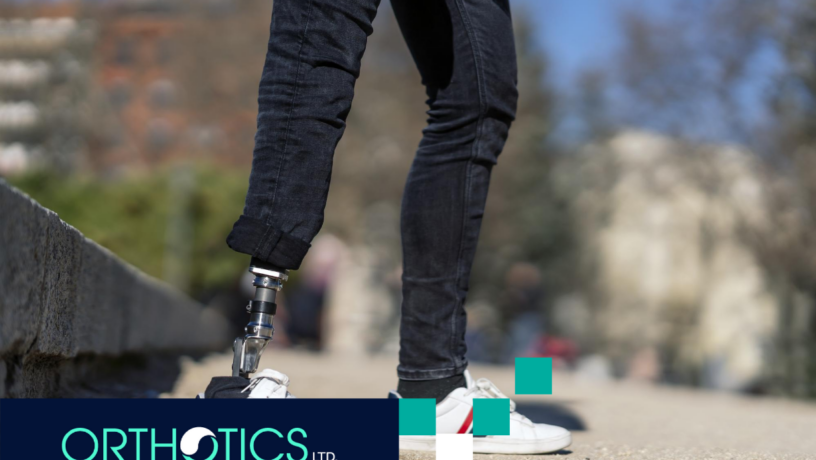 An amputee wearing a prosthetic standing outdoors wearing jeans and white shoes