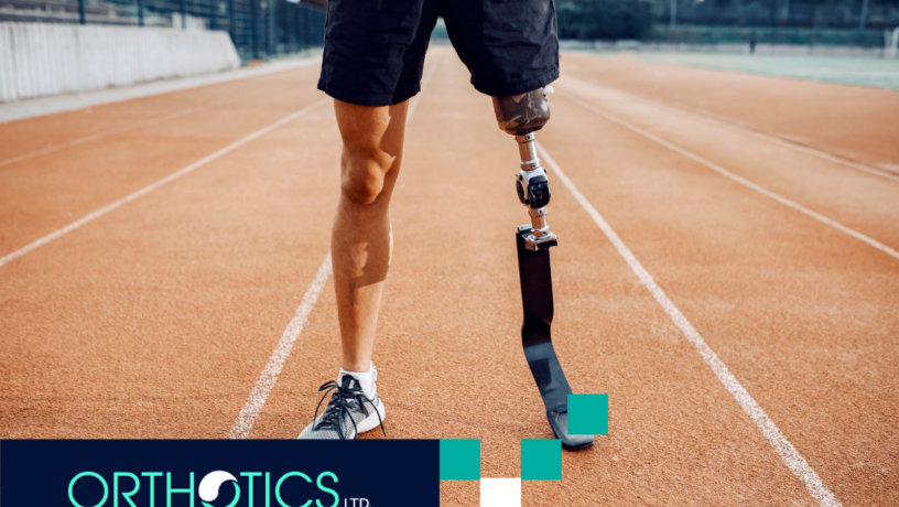 An athletic amputee wearing prosthetic standing in a track field