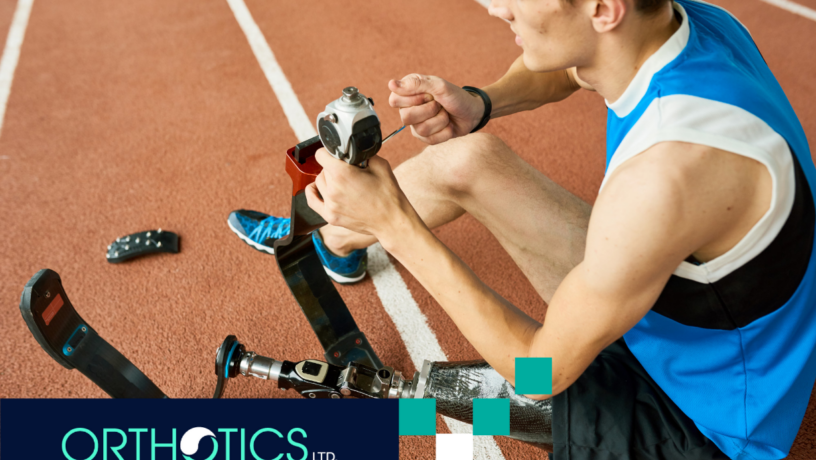 An amputee athlete fixing his prosthetic