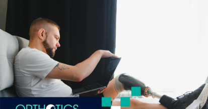 A man wearing prosthetics sitting on a couch