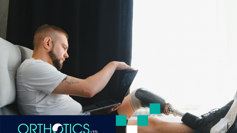 A man wearing prosthetics sitting on a couch