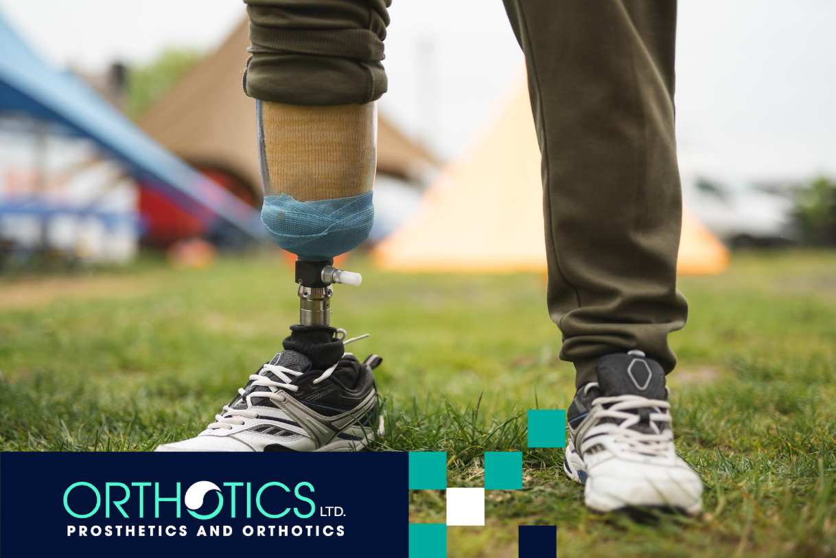 An amputee wearing a prosthetic leg standing on the grass