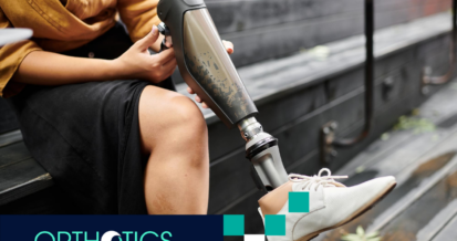 An amputee holding his prosthetic while sitting on a bench