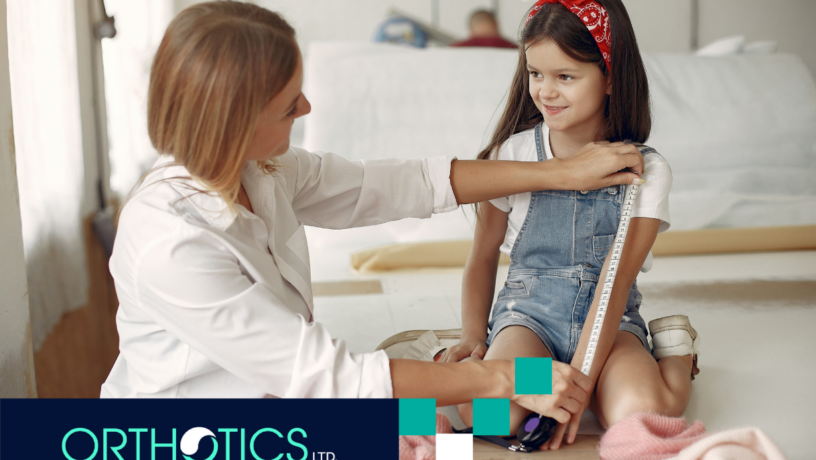 A prosthetist measuring a girl's arm using tape measure