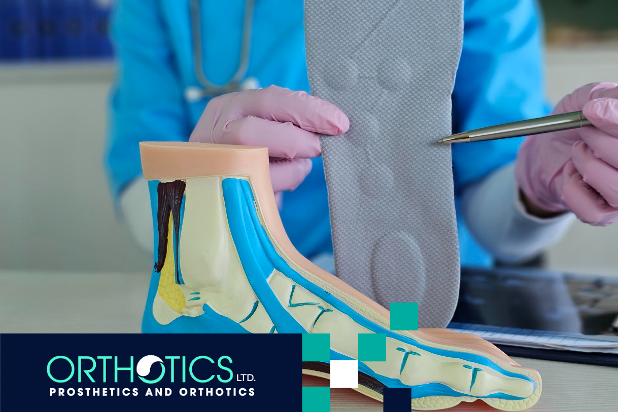 A medical assistant holding an orthotic insole, with a model of a foot on a table