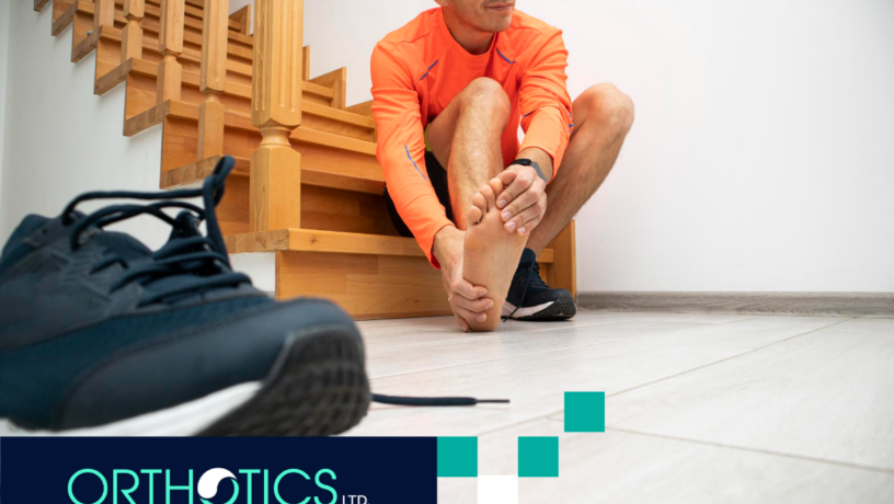 A man is holding his hurting foot