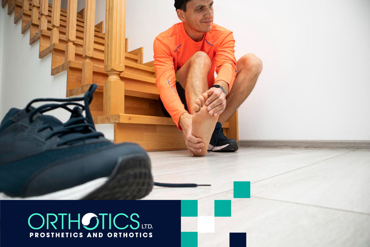 A man is holding his hurting foot