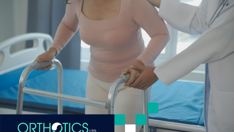 An amputee with a large body type is walking using a walker assisted by a doctor