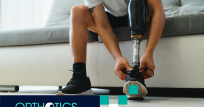 An amputee sitting on a couch wearing his prosthetic leg