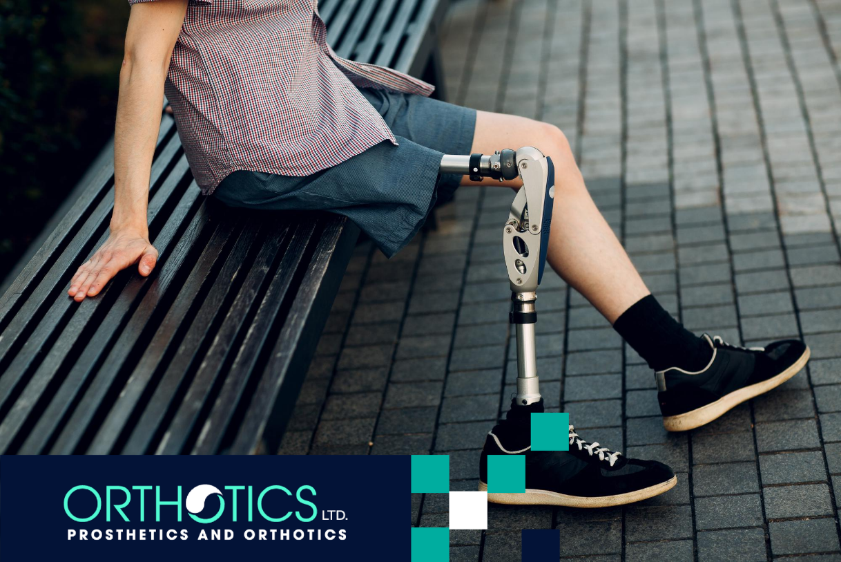 An amputee wearing prosthetics sitting on a bench outdoors