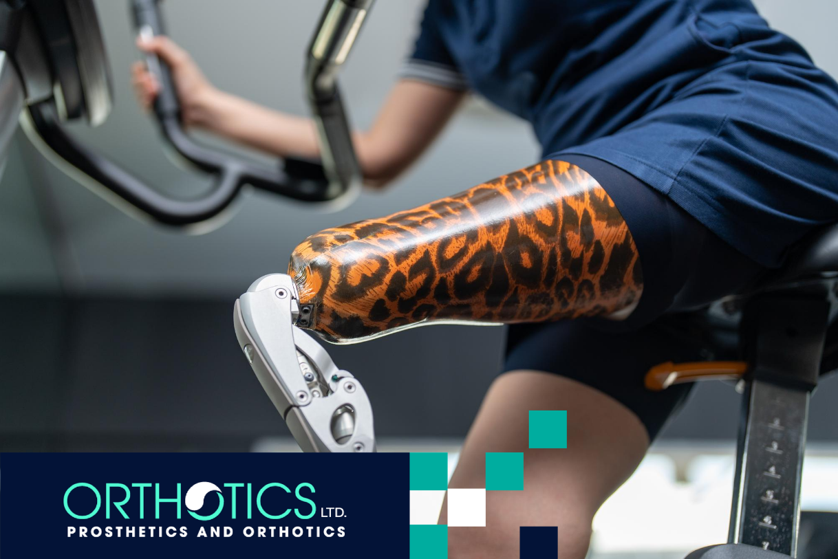 An amputee wearing a prosthetic with cosmetic covers on a gym bike