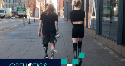 Two amputees wearing prosthetics walking together outdoors
