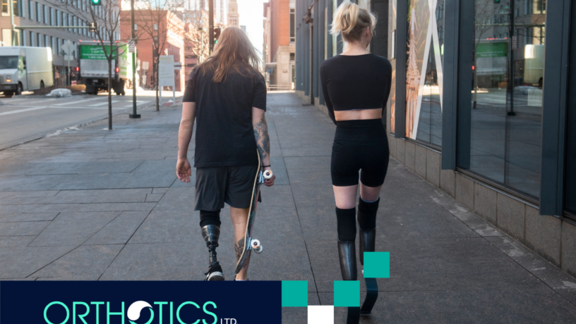 Two amputees wearing prosthetics walking together outdoors
