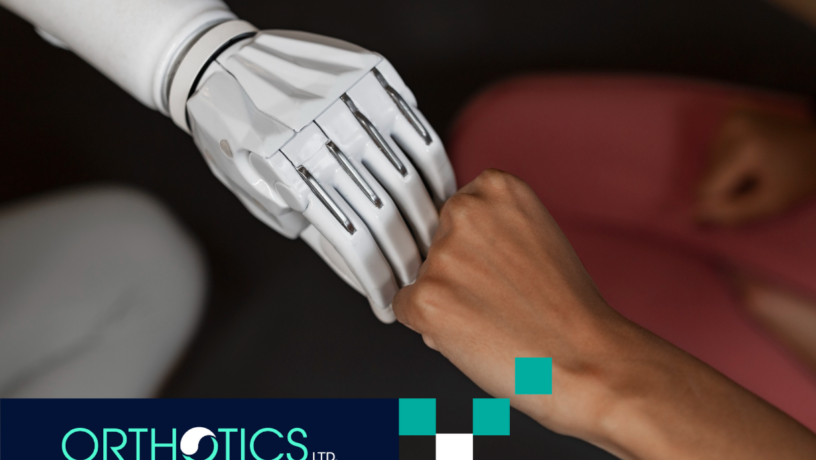 An amputee wearing a prosthetic arm fist-bumping another hand