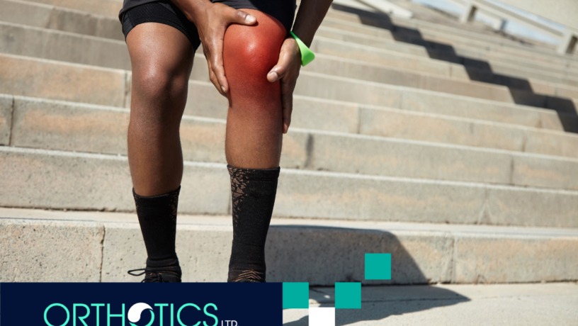 A man holding his knee in pain