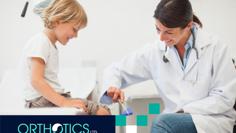 A child's leg being checked by a doctor