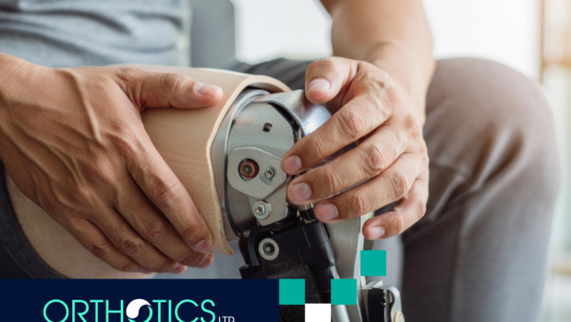 A man wearing prosthetic sitting on a couch