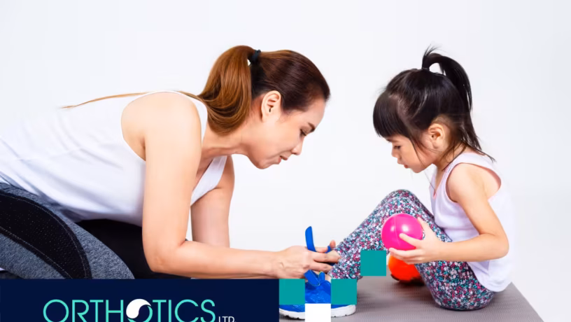A child getting her orthotic checked by her mother
