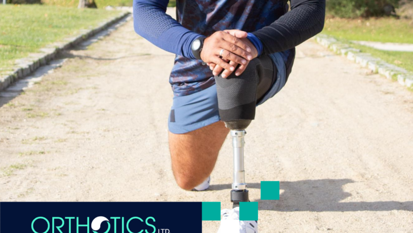 An amputee wearing a prosthetic stretching outdoors