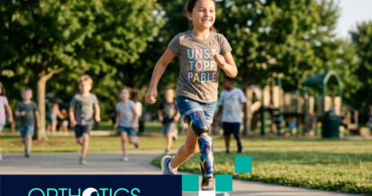 A kid wearing prosthesis running outdoors
