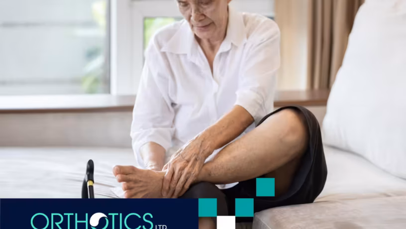 An elderly woman holding her foot, about to wear an orthotic bracing after stroke