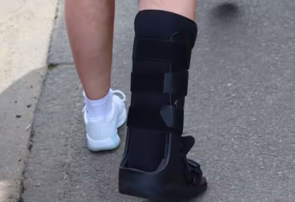 A person wearing CROW boot walking outdoors