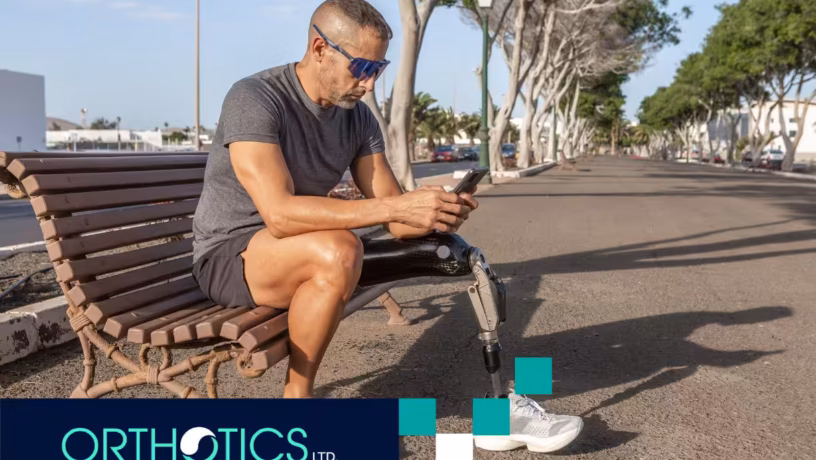 A man sitting on a bench looking at tips on prosthetic socket care in summer