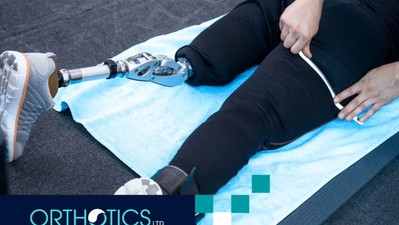 A person wearing limb prosthetics lying on a floor mat