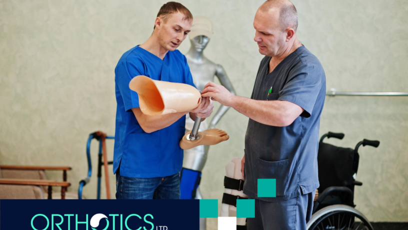 Two prosthetist men holding a prosthetic leg